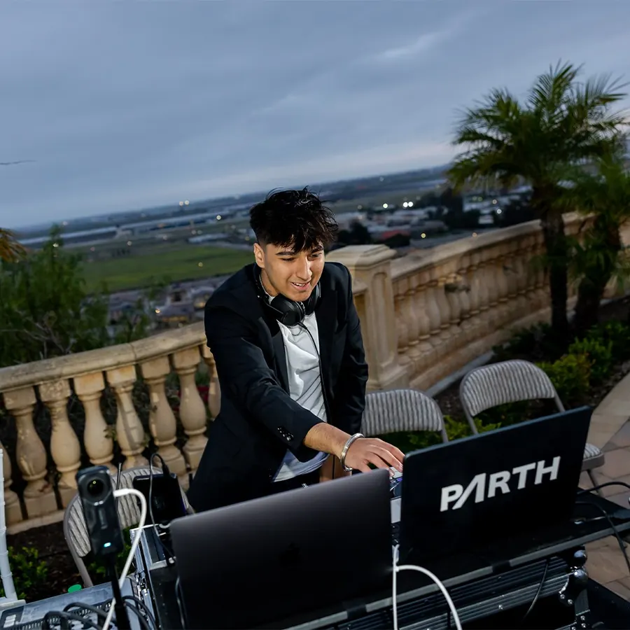 DJ at the booth under deep violet stage lighting